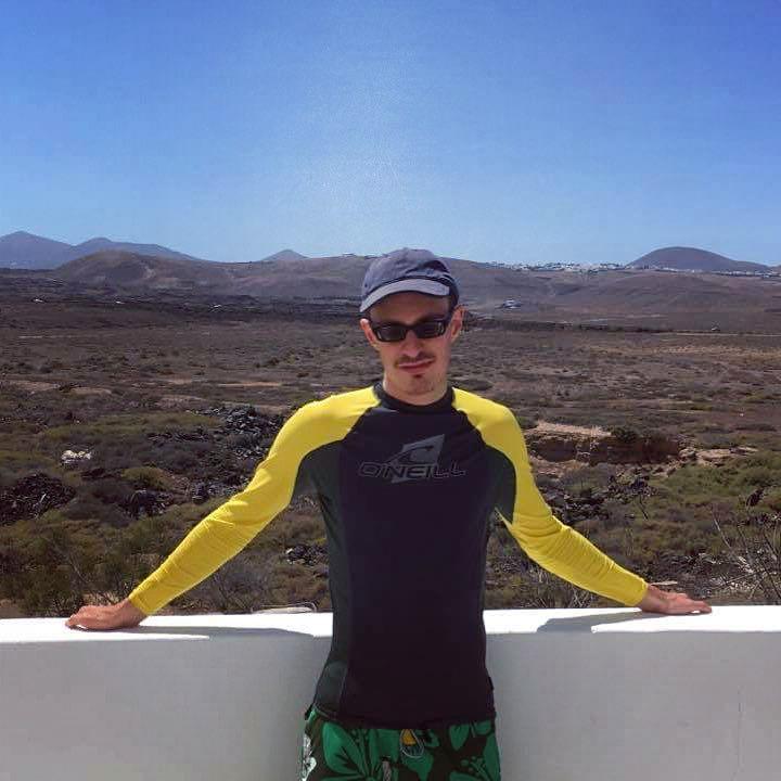 Lewis in Lanzarote with the hills behind him.